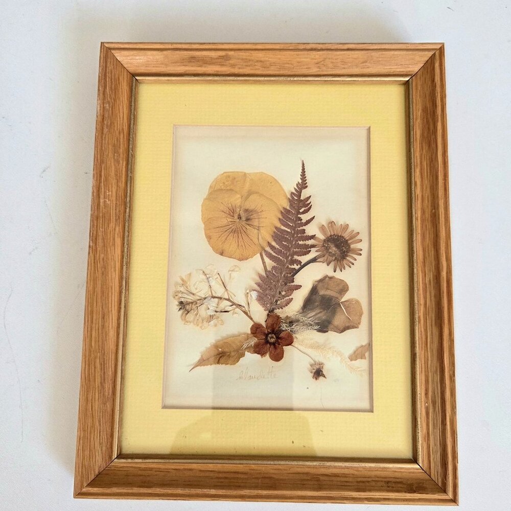 Handmade dry pressed flowers in wooden frame.